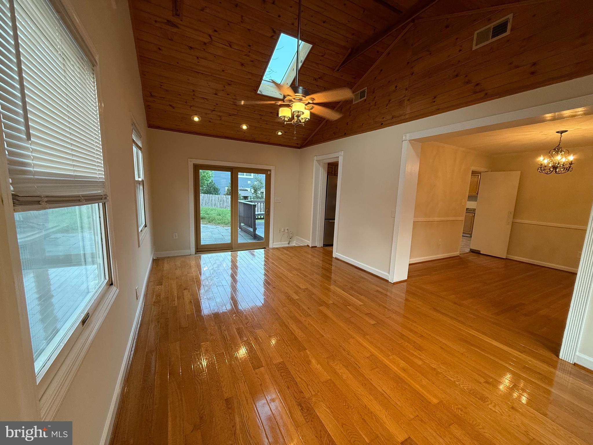 6209 Redwing Road Bethesda, MD 20817 - Photo 9 of 27 a view of hallway with wooden floor and chandelier