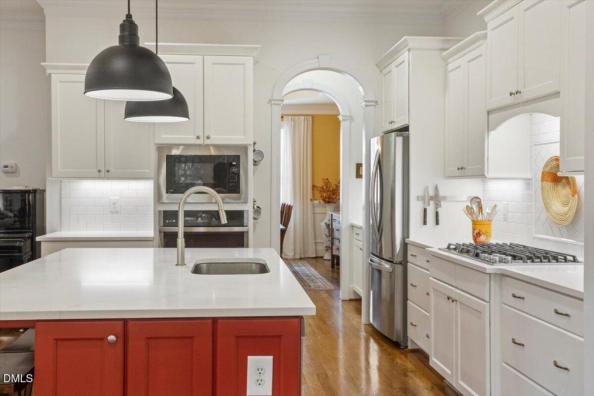 904 Prairie Smoke Street Wake Forest, NC 27587 - Photo 15 of 61 a kitchen with stainless steel appliances granite countertop a sink a stove and a refrigerator