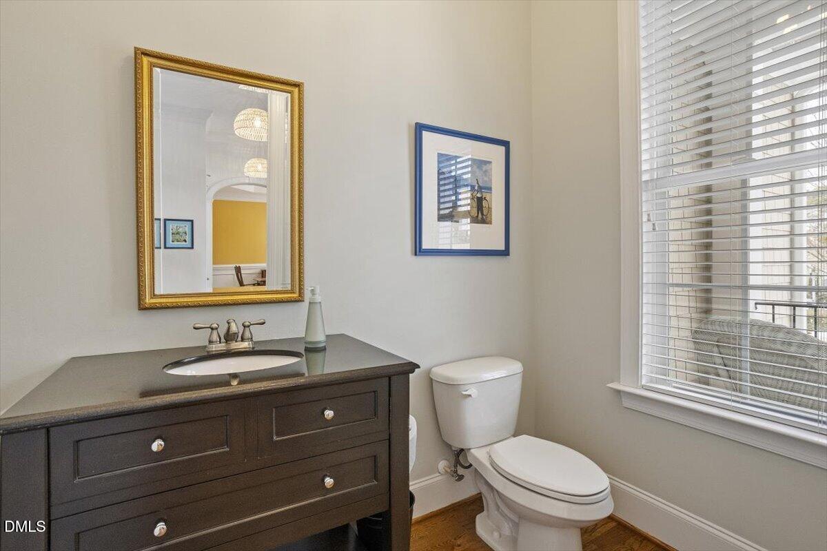 904 Prairie Smoke Street Wake Forest, NC 27587 - Photo 26 of 61 a bathroom with a toilet a sink and mirror