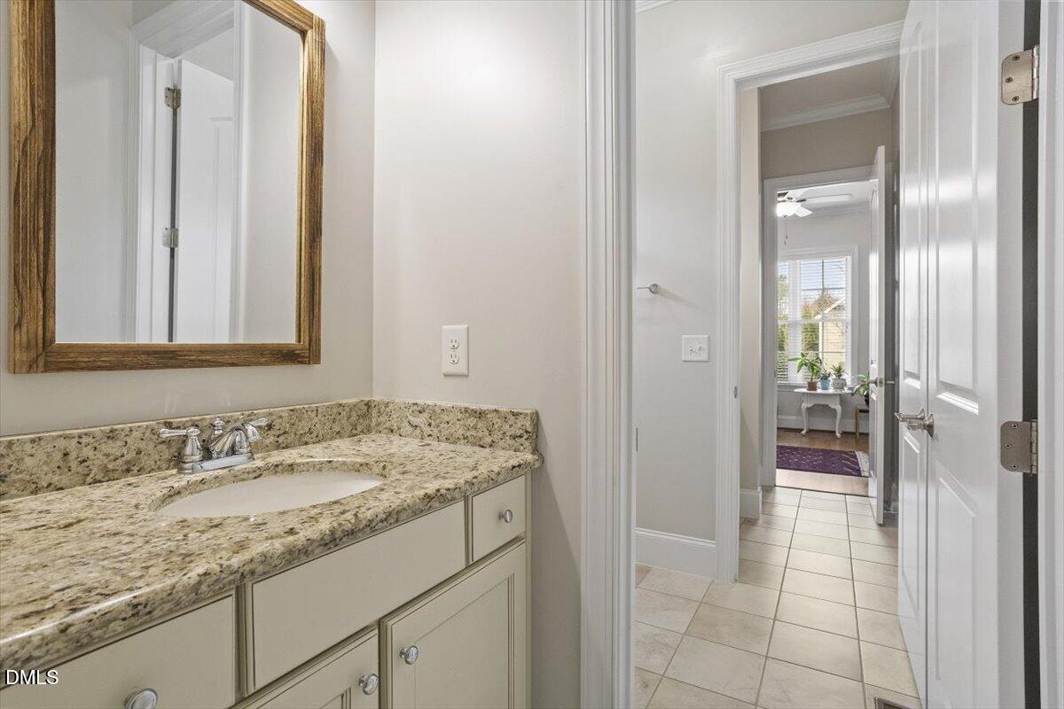 904 Prairie Smoke Street Wake Forest, NC 27587 - Photo 46 of 61 a bathroom with a granite countertop sink and a mirror