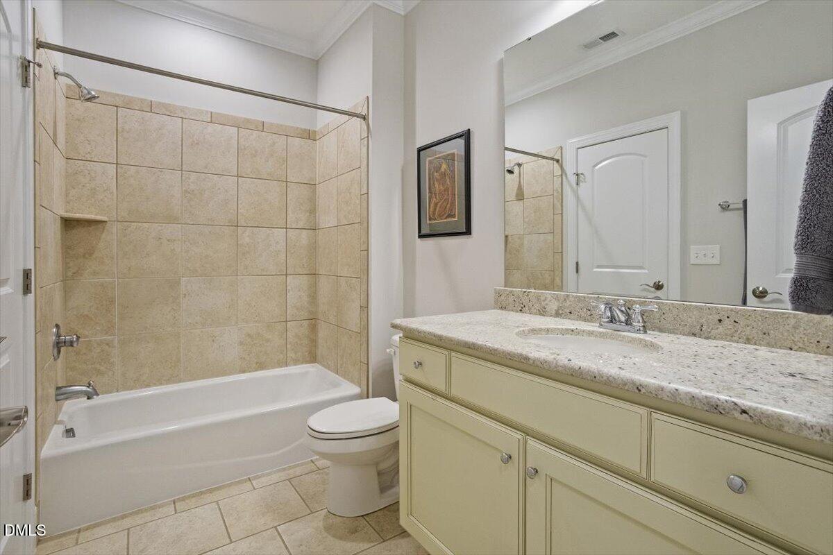 904 Prairie Smoke Street Wake Forest, NC 27587 - Photo 50 of 61 a bathroom with a granite countertop sink a toilet and bathtub
