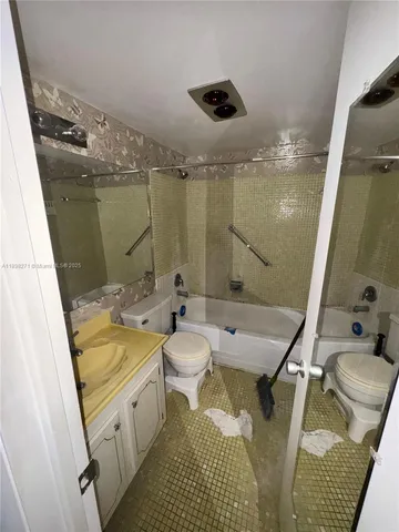 a bathroom with a granite countertop sink a toilet and shower