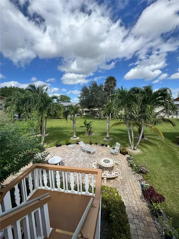 a view of yard with swimming pool and green space