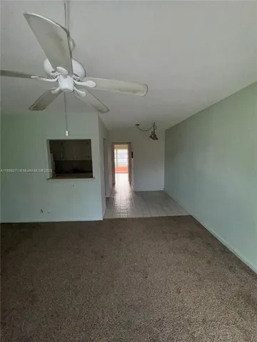 a view of a livingroom with a ceiling fan and a fan