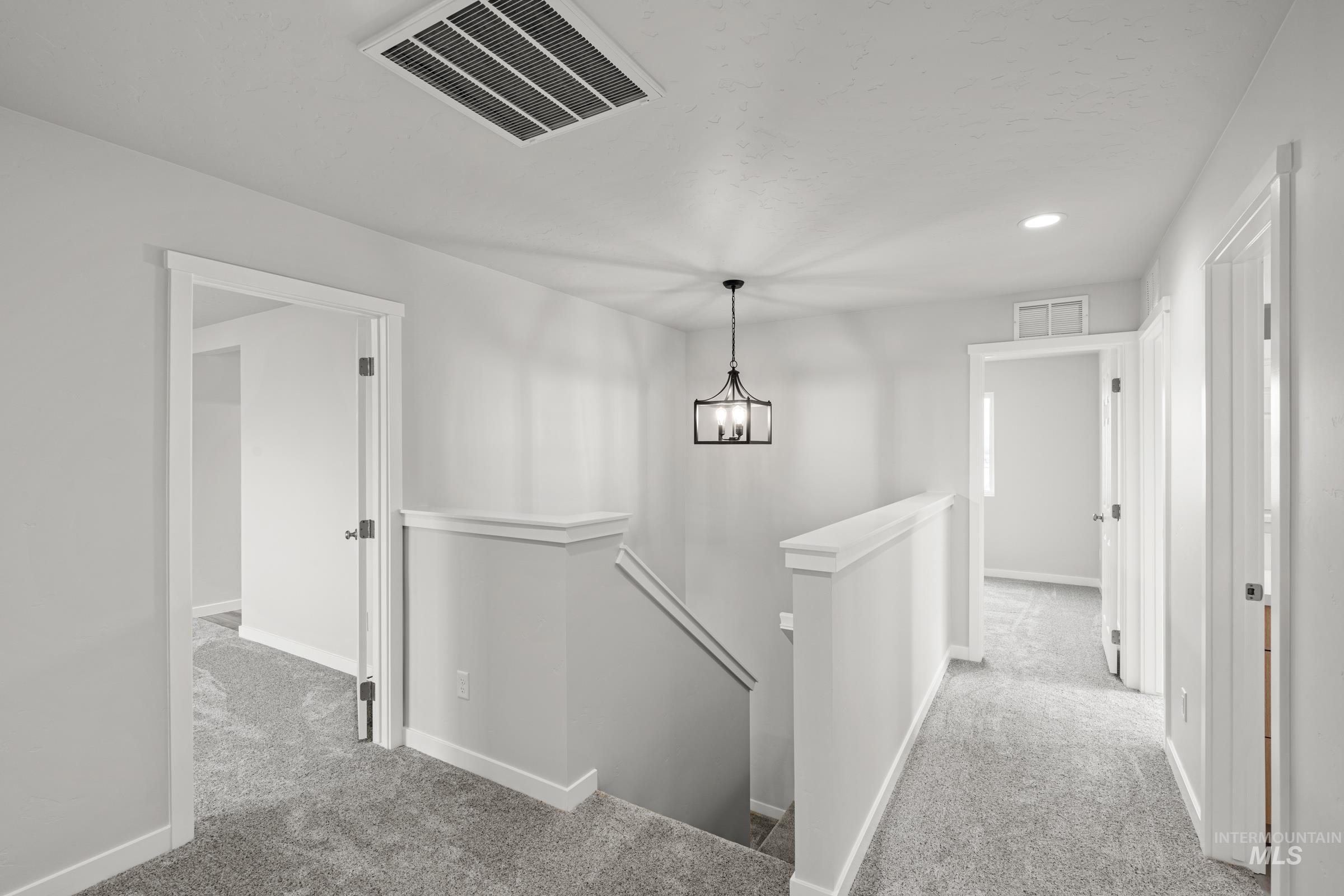14056 Shiny Spruce Street Caldwell, ID 83607 - Photo 12 of 25 Upper-level hallway with gray carpeting and white trim