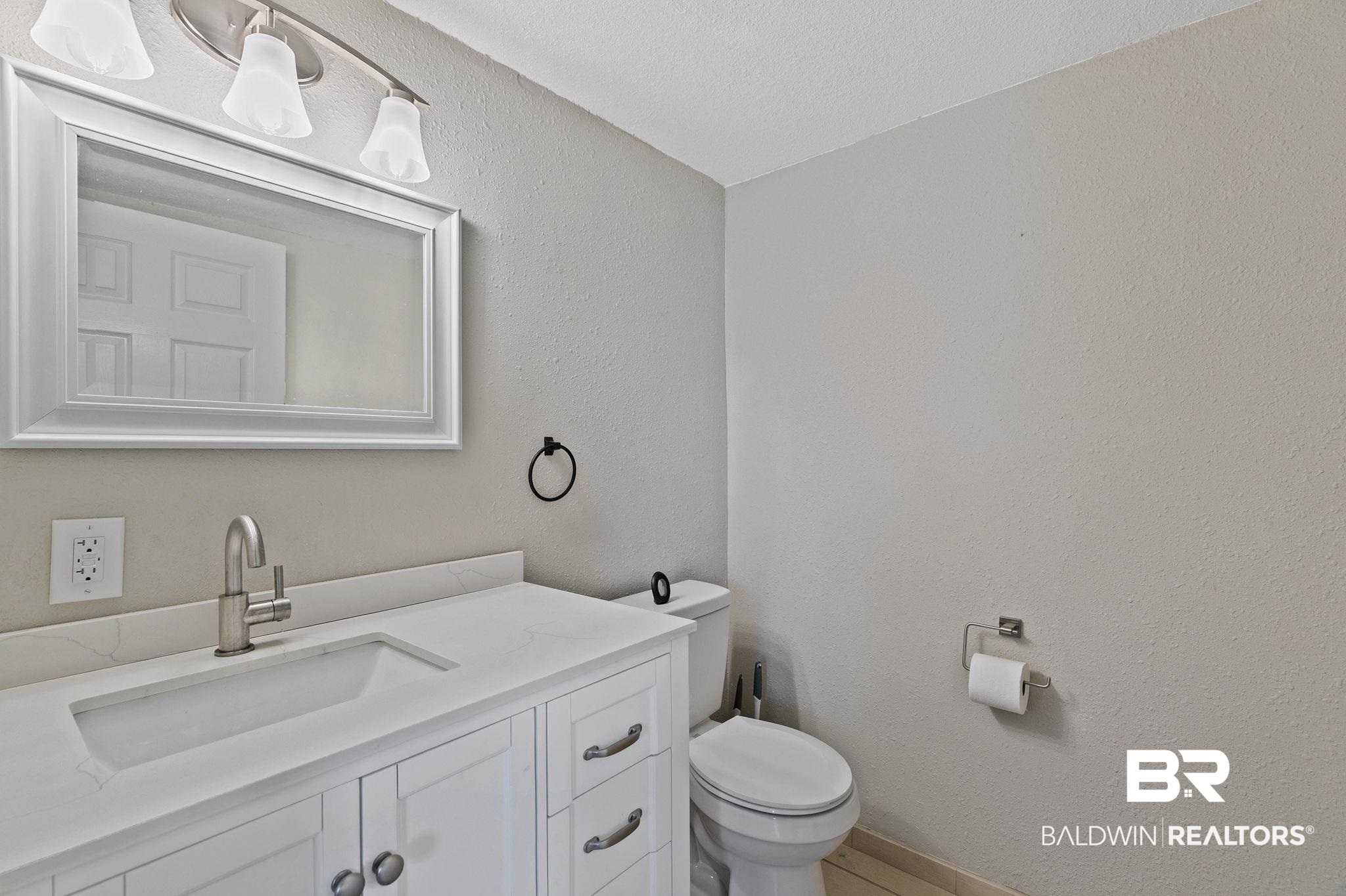 16796 Thompson Road Loxley, AL 36551 - Photo 36 of 93 Half bathroom featuring a textured wall and vanity