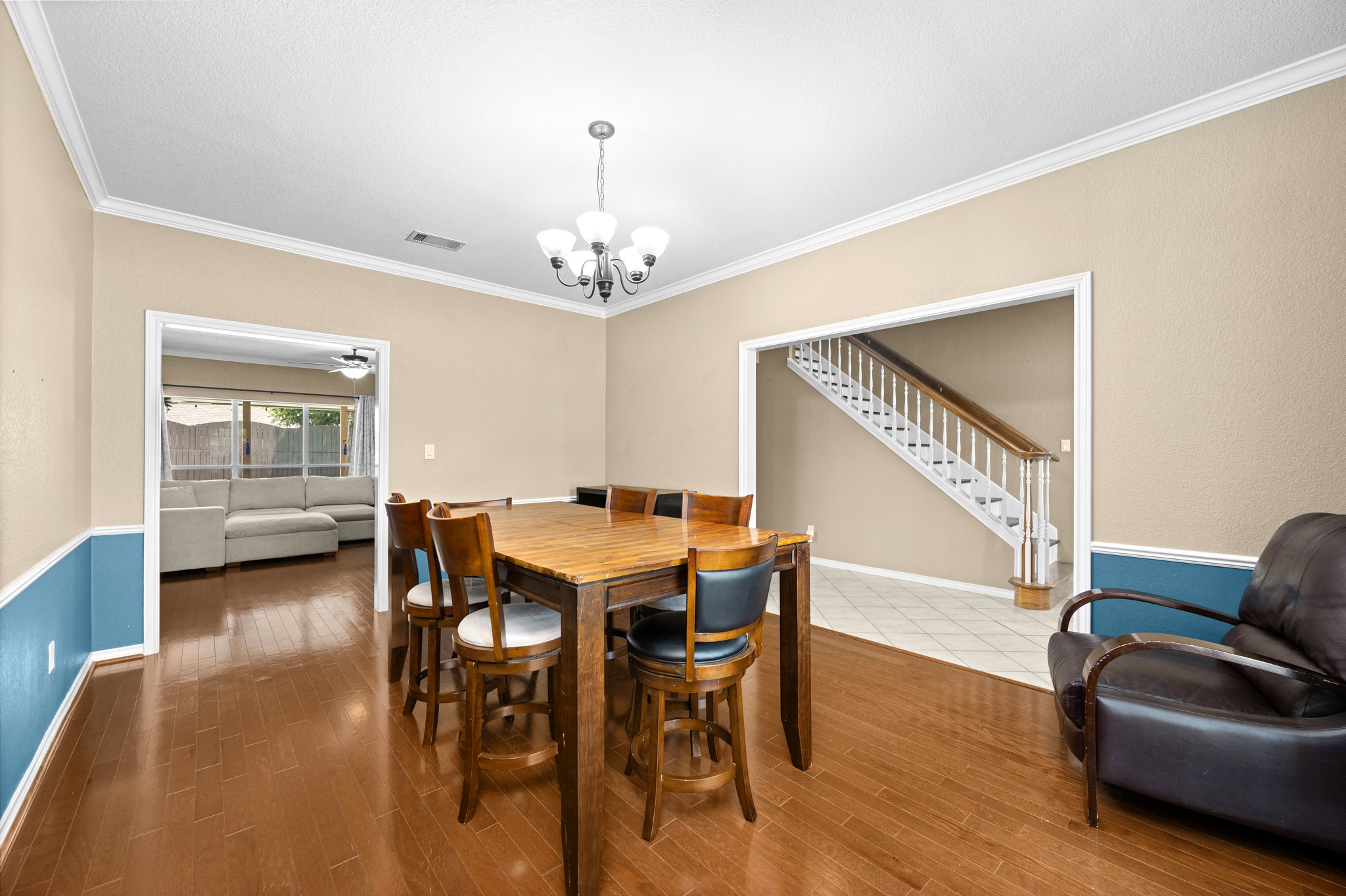 108 Thornwood Road Georgetown, TX 78628 - Photo 5 of 40 Hardwood floors stretch across this open dining area, connecting to a separate living space.