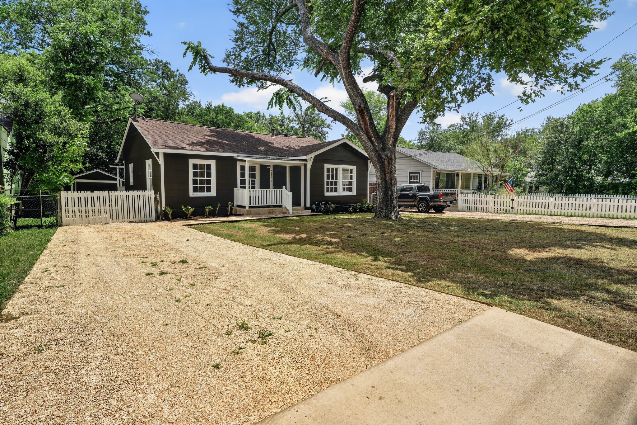 4907 Duval Street Austin, TX 78751 - Photo 2 of 31 a front view of a house with a garden and trees
