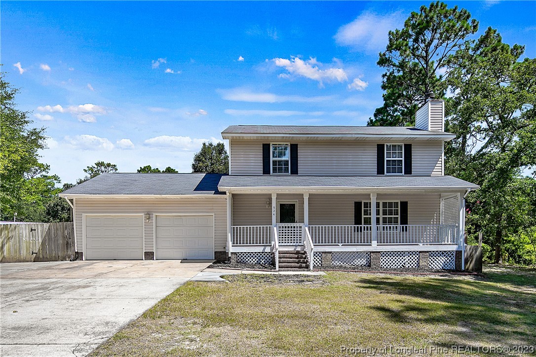 a view of a house with a garden and yard