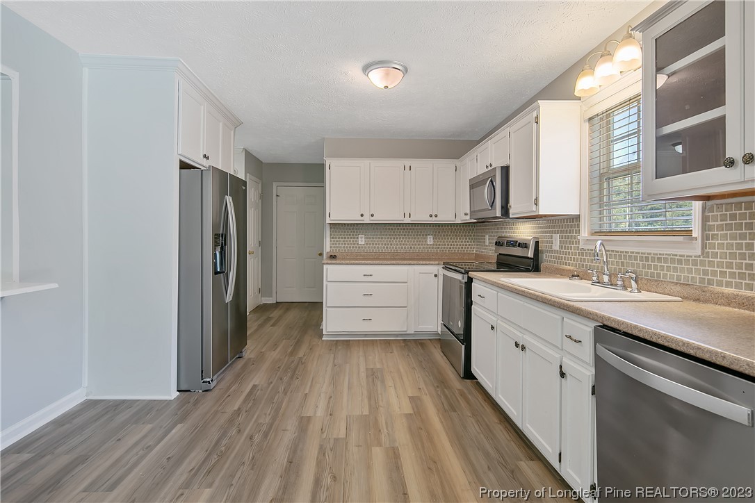 624 Porter Road Hope Mills, NC 28348 - Photo 15 of 45 a kitchen with cabinets oven and a sink