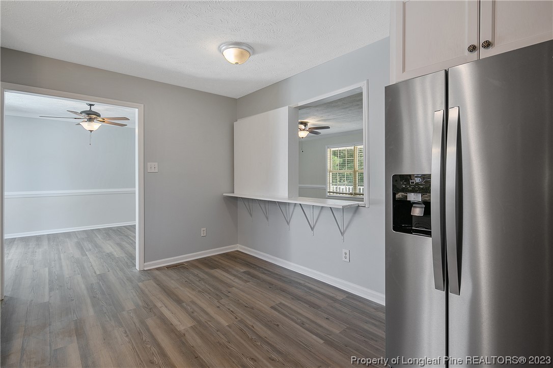 624 Porter Road Hope Mills, NC 28348 - Photo 19 of 45 a view of a kitchen with wooden floors and refrigerator