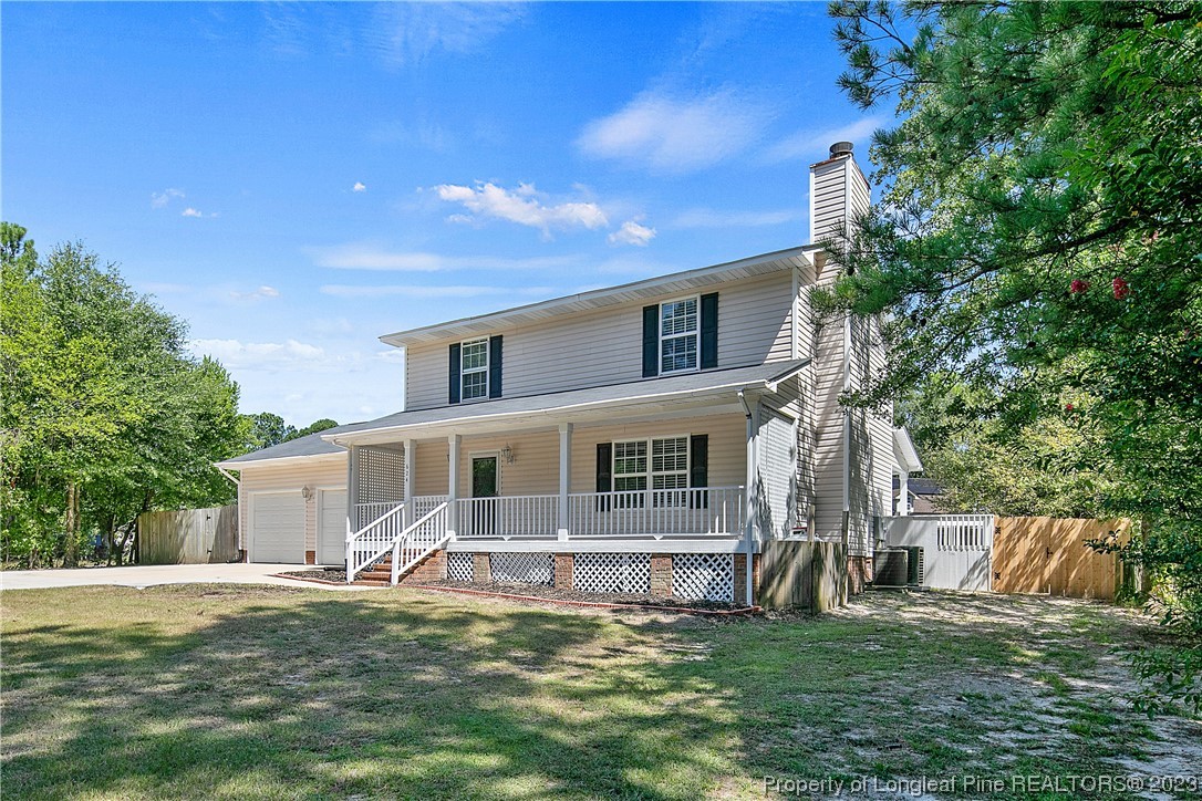 624 Porter Road Hope Mills, NC 28348 - Photo 2 of 45 a view of a house with a big yard and a large tree
