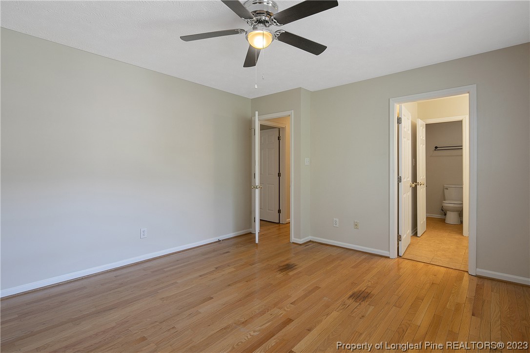 624 Porter Road Hope Mills, NC 28348 - Photo 24 of 45 an empty room with wooden floor a ceiling fan and closet