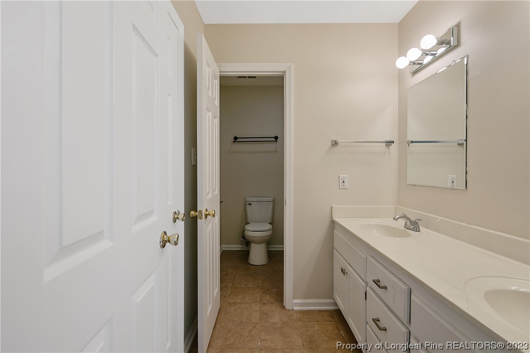 624 Porter Road Hope Mills, NC 28348 - Photo 26 of 45 a bathroom with a double vanity sink toilet and shower