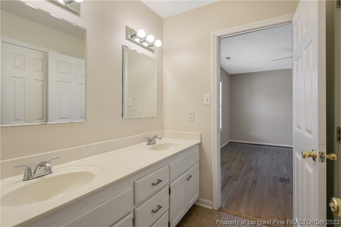624 Porter Road Hope Mills, NC 28348 - Photo 28 of 45 a bathroom with a double vanity sink and mirror