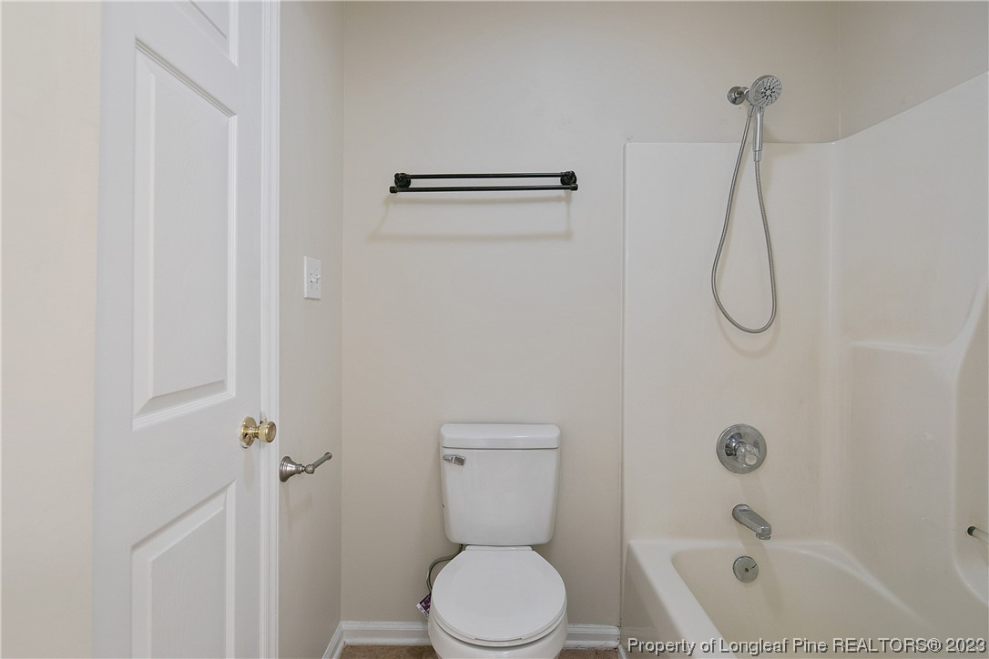 624 Porter Road Hope Mills, NC 28348 - Photo 29 of 45 a bathroom with a granite countertop toilet and a shower