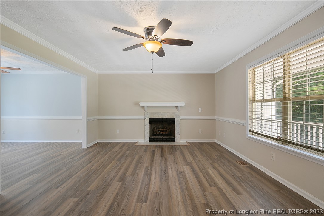 624 Porter Road Hope Mills, NC 28348 - Photo 7 of 45 wooden floor fireplace and windows in an empty room