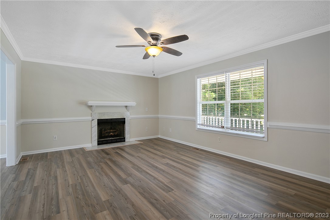 624 Porter Road Hope Mills, NC 28348 - Photo 8 of 45 a view of an empty room with wooden floor fireplace and a window