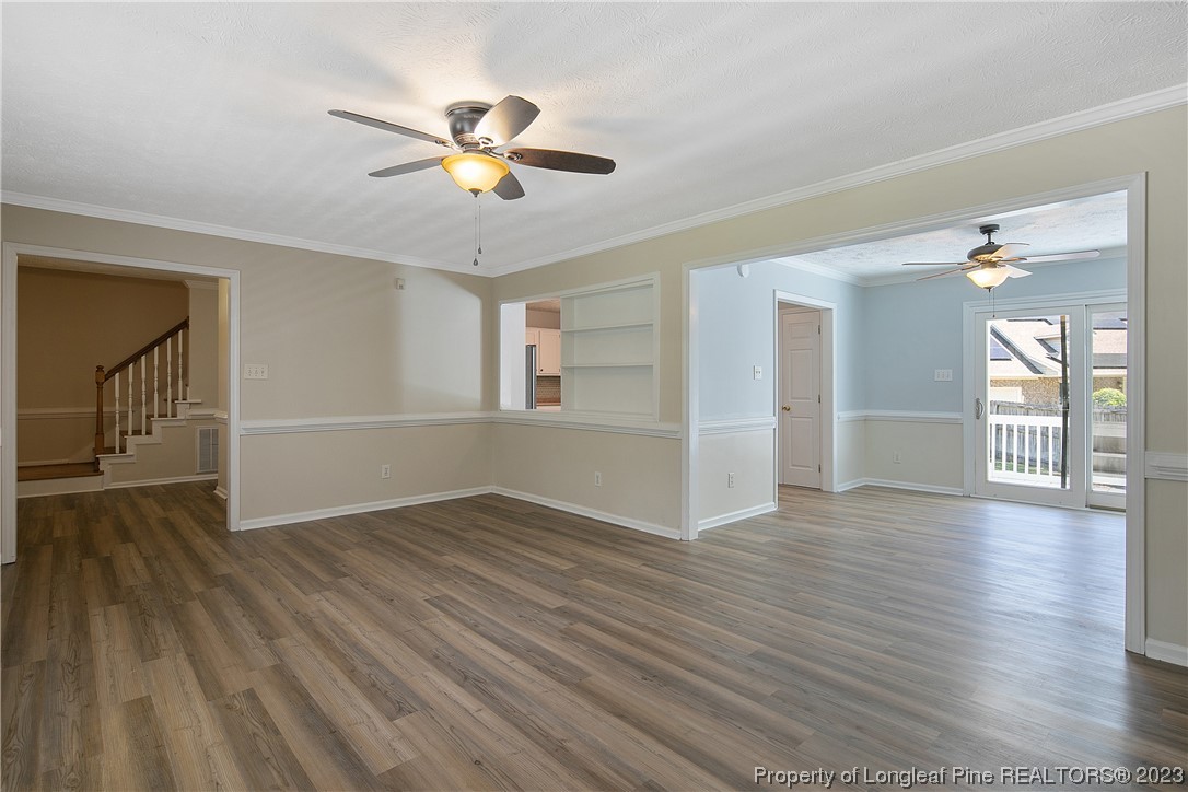 624 Porter Road Hope Mills, NC 28348 - Photo 10 of 45 a view of an empty room with wooden floor and a ceiling fan