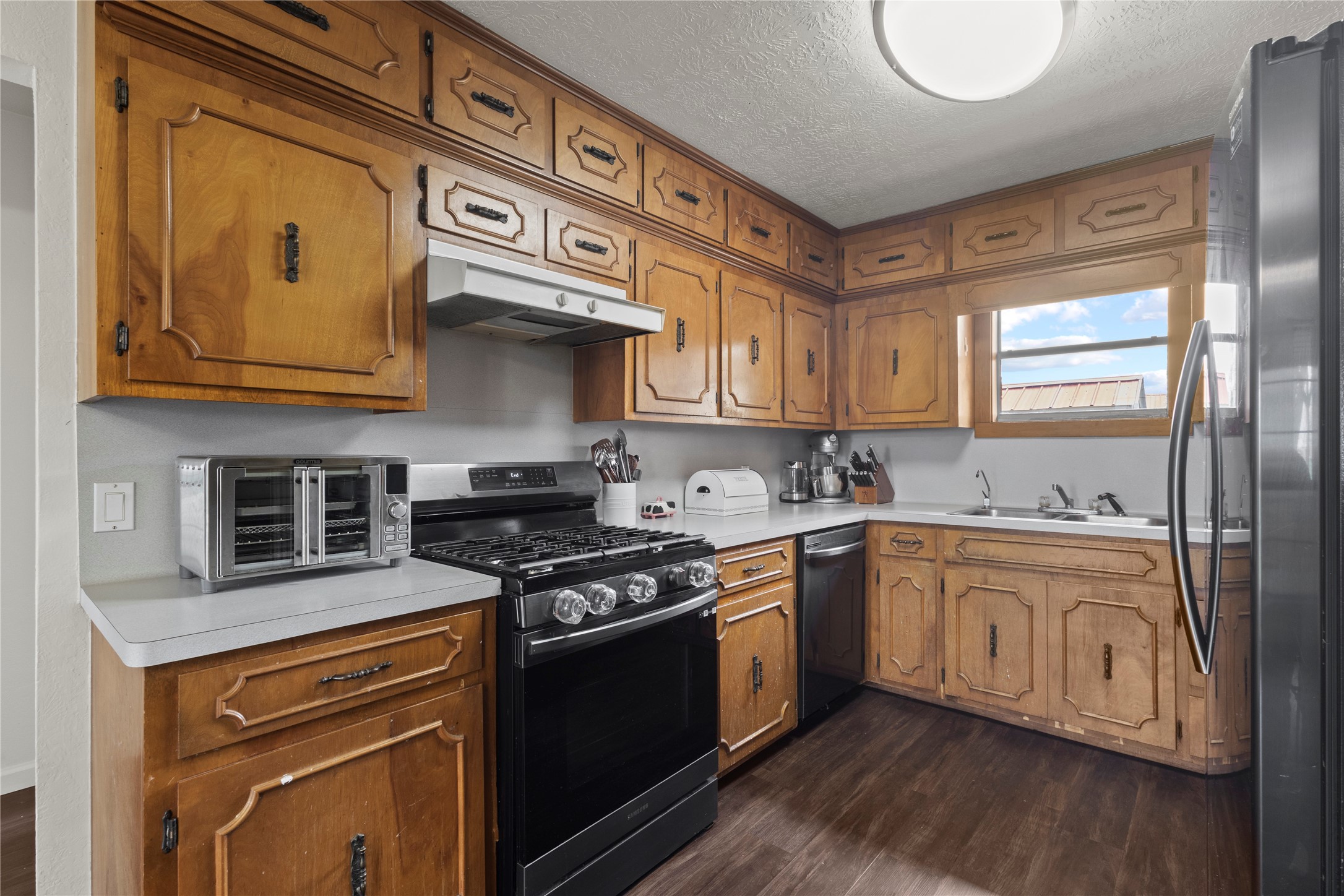 19961 Englin Road Winnie, TX 77665 - Photo 16 of 26 a kitchen with stainless steel appliances granite countertop a stove and a sink