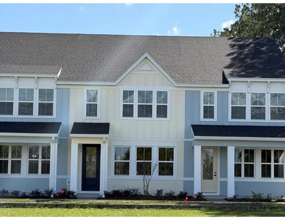 a view of house with yard in front of it