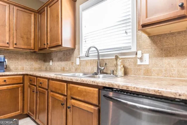 a kitchen with granite countertop a sink and a window