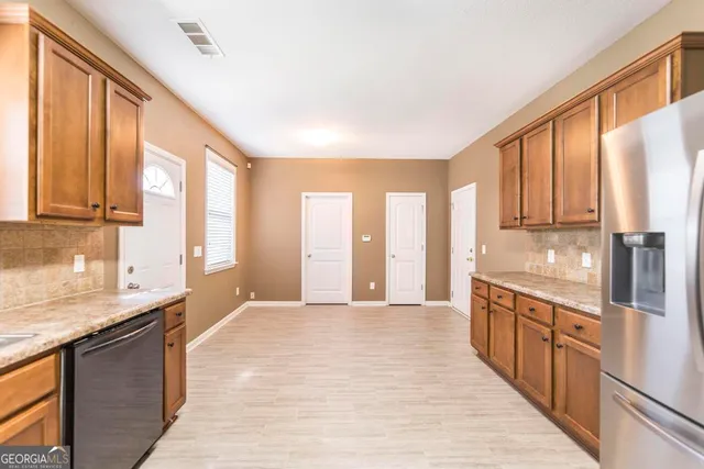 a large kitchen with kitchen island granite countertop a large window