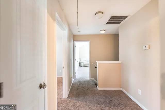 a view of a hallway with white walls