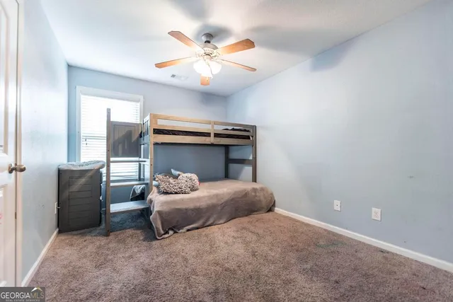 a bedroom with a bed and a painting on the wall