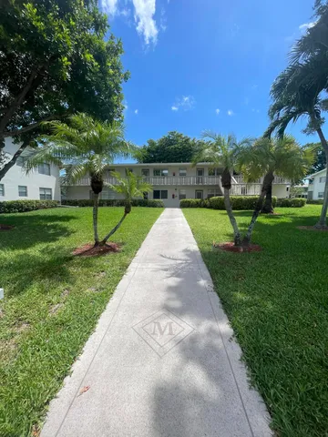 a view of a room with furniture and windows