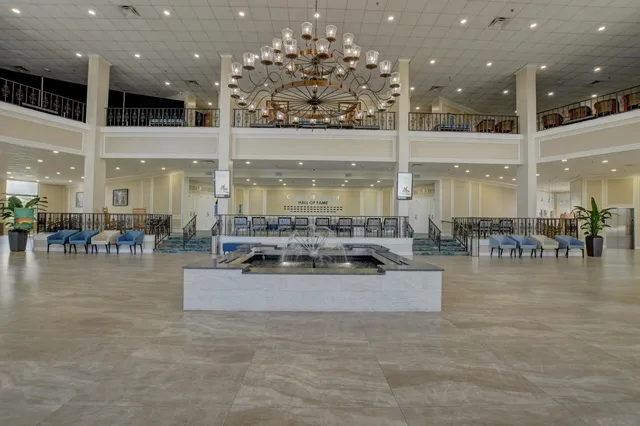 a room with lots of furniture a dining table and chairs with wooden floor