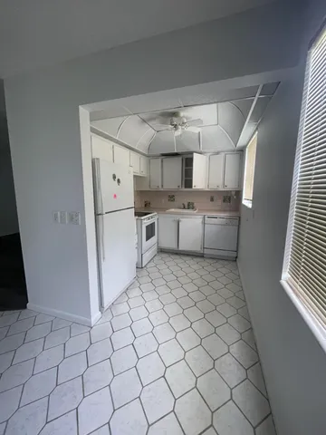 a utility room with cabinets washer and dryer