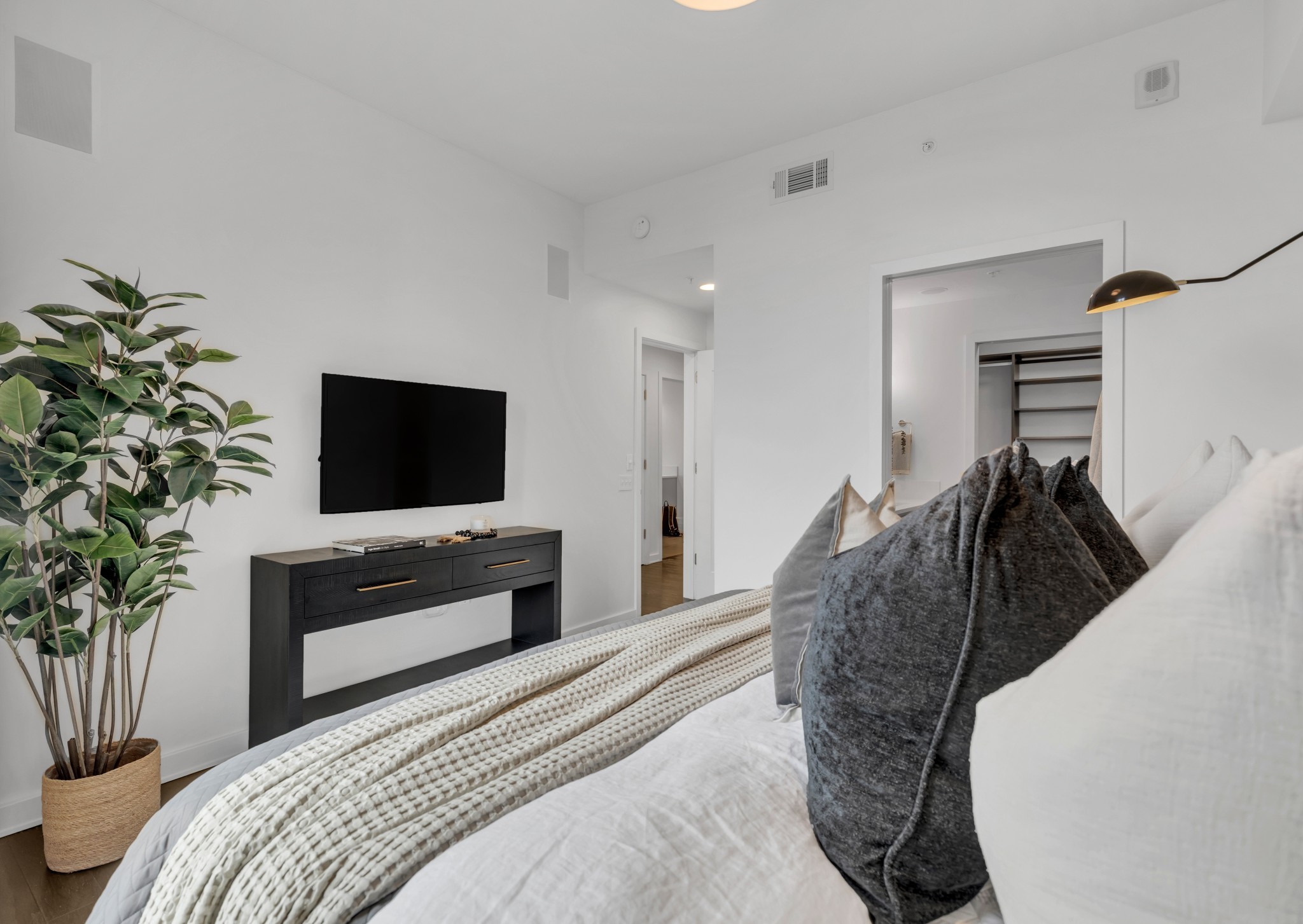 1212 Laurel Street, Unit 1815 Nashville, TN 37203 - Photo 11 of 42 a bedroom with a bed and a flat screen tv