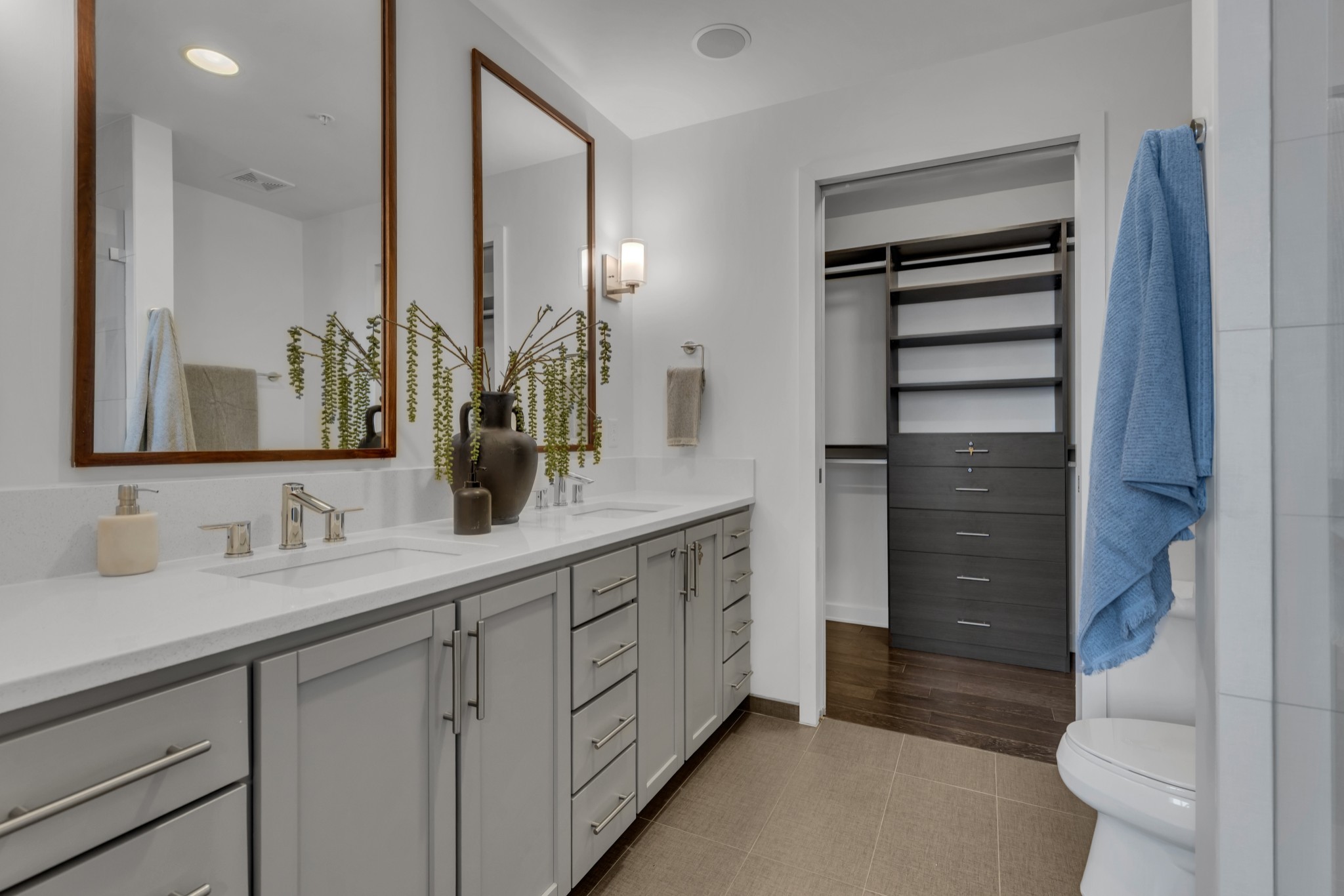 1212 Laurel Street, Unit 1815 Nashville, TN 37203 - Photo 12 of 42 a bathroom with a double vanity sink a toilet and a mirror