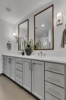 a bathroom with a double vanity sink and a mirror