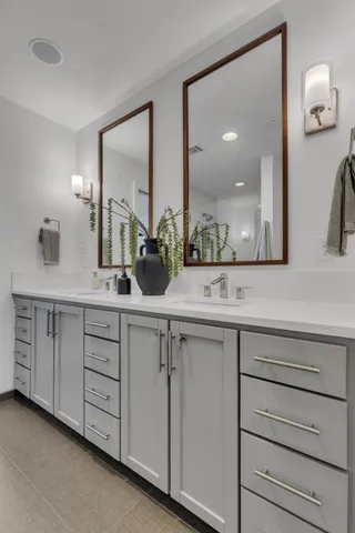 a bathroom with a double vanity sink and a mirror