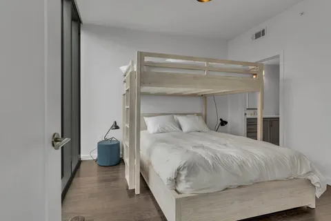 a bedroom with a bed and a mirror