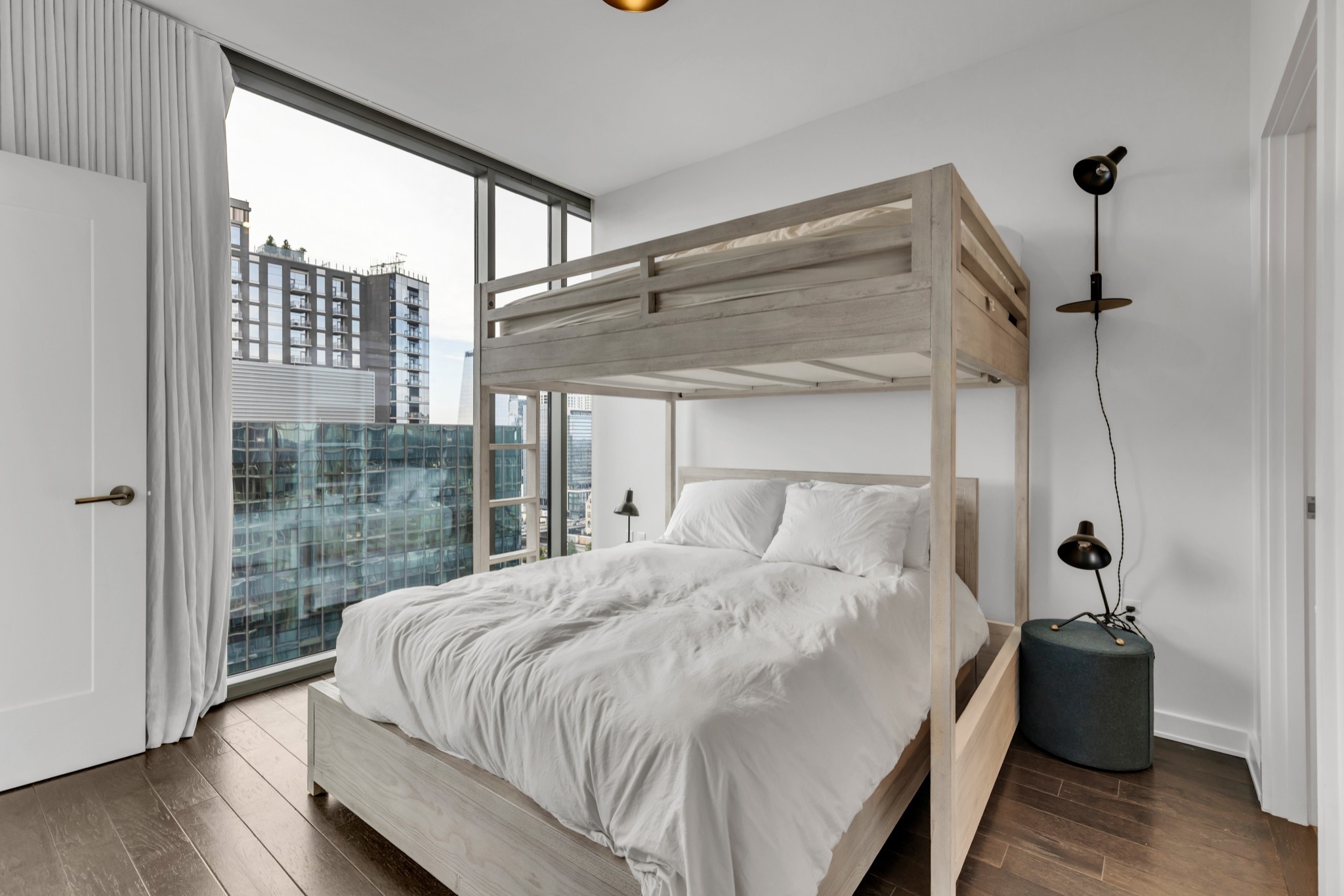 1212 Laurel Street, Unit 1815 Nashville, TN 37203 - Photo 17 of 42 a bedroom with a bed and a large window