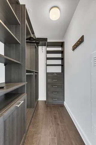 a view of walk in closet with empty racks