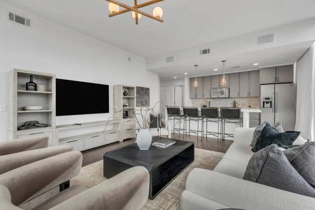 a living room with furniture wooden floor and a flat screen tv