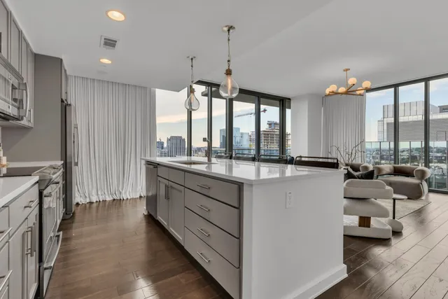 a large kitchen with kitchen island granite countertop a large window