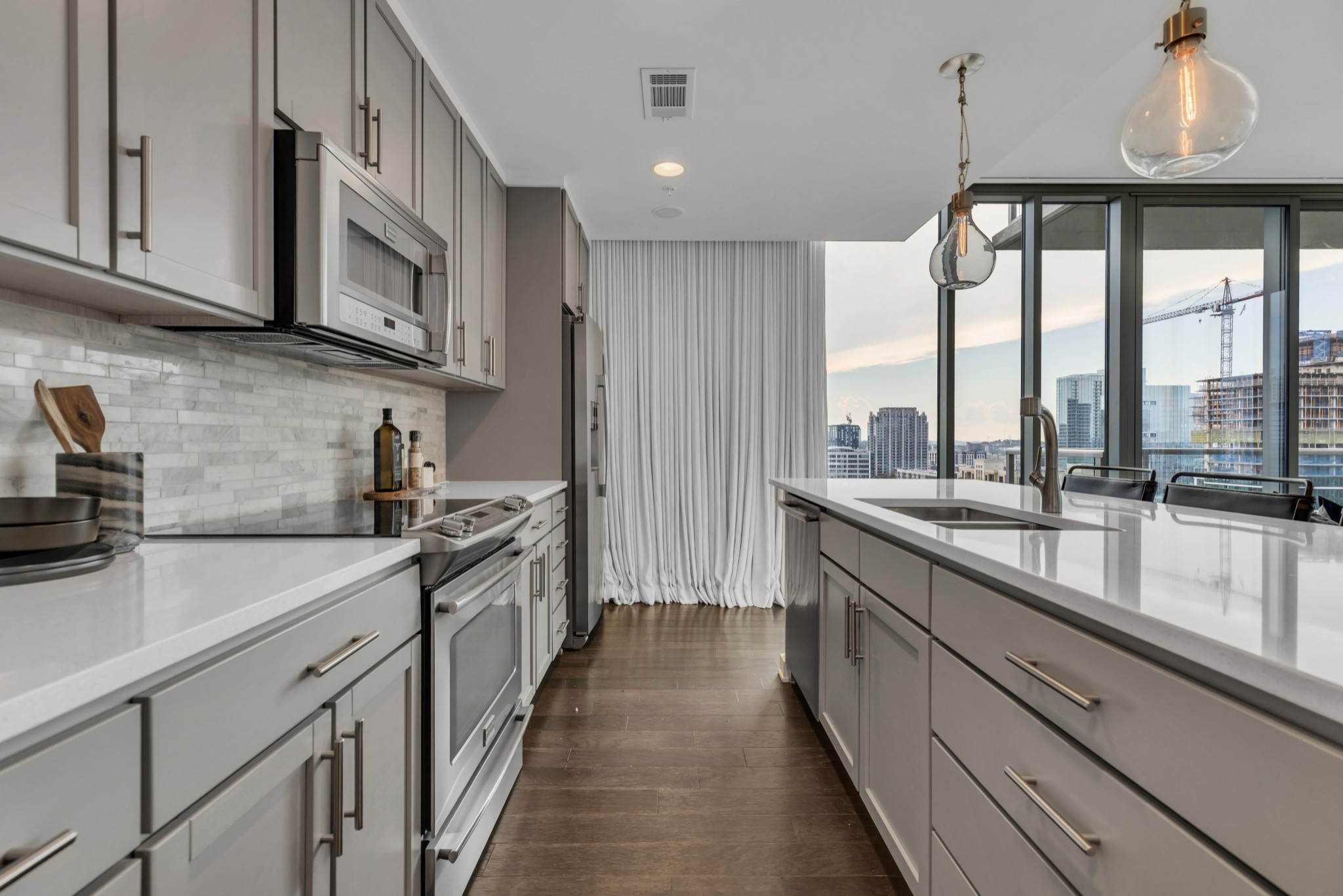 1212 Laurel Street, Unit 1815 Nashville, TN 37203 - Photo 6 of 42 a kitchen with stainless steel appliances granite countertop a sink a stove and cabinets