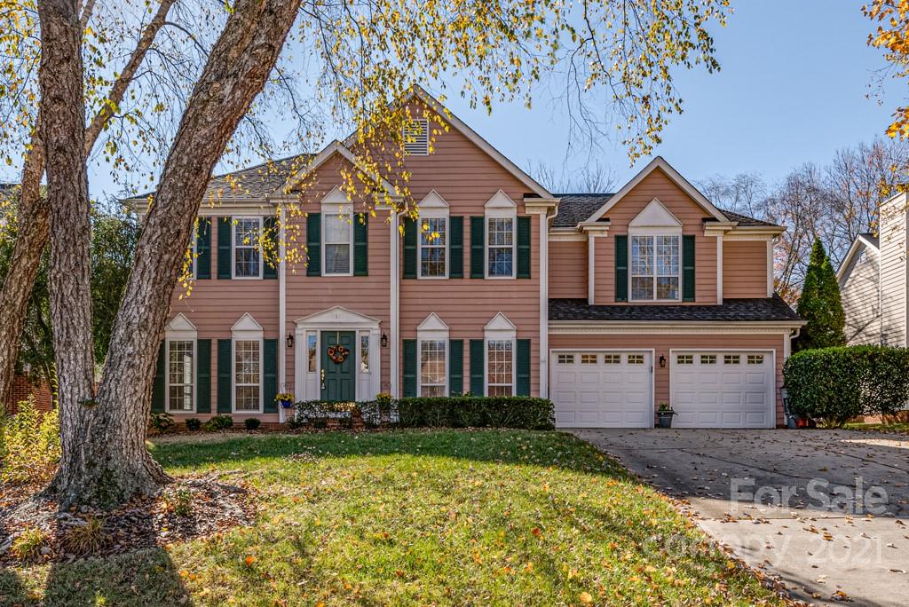4511 Brownes Ferry Road Charlotte, NC 28269 - Photo 1 of 26 a front view of a house with a yard and garage