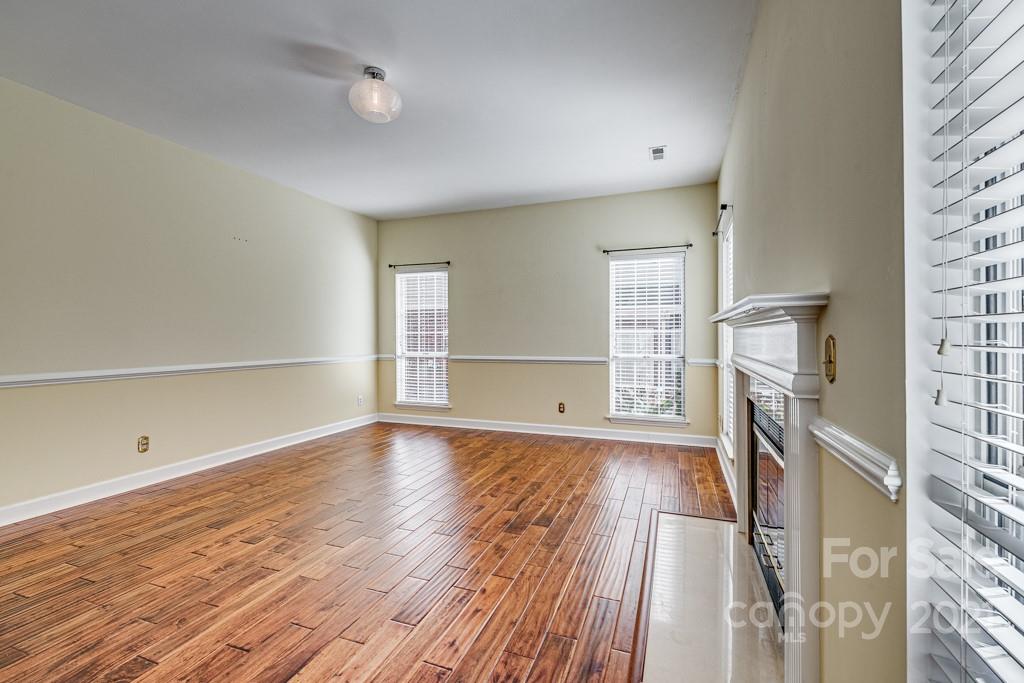 4511 Brownes Ferry Road Charlotte, NC 28269 - Photo 11 of 26 a view of empty room with wooden floor and fan
