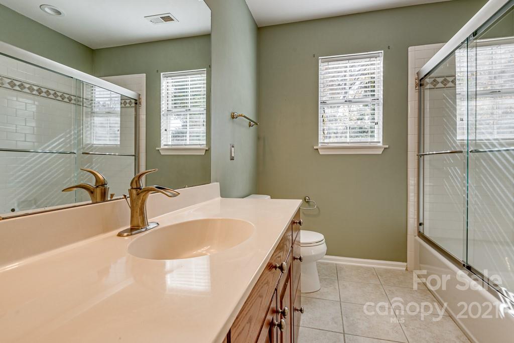 4511 Brownes Ferry Road Charlotte, NC 28269 - Photo 18 of 26 a bathroom with a sink and a tub