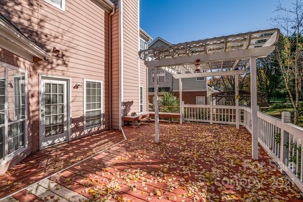 4511 Brownes Ferry Road Charlotte, NC 28269 - Photo 21 of 26 a view of a porch with wooden stairs and a bench