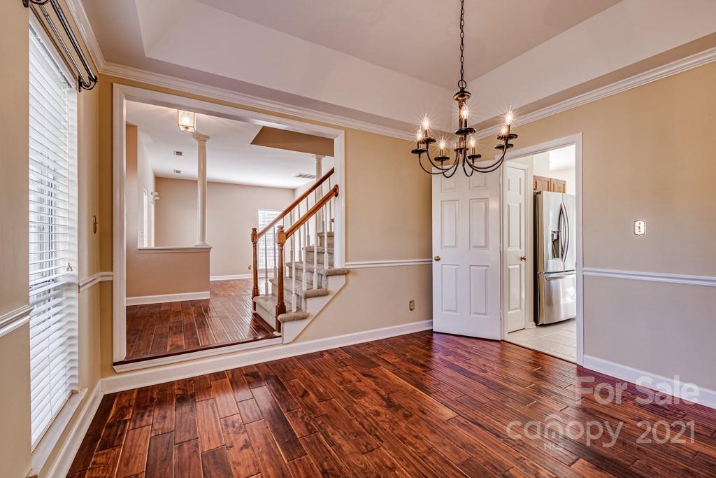 4511 Brownes Ferry Road Charlotte, NC 28269 - Photo 5 of 26 a view of a livingroom with wooden floor staircase and a kitchen