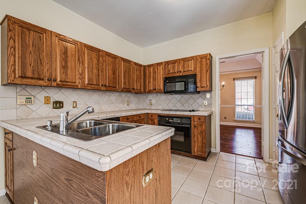 4511 Brownes Ferry Road Charlotte, NC 28269 - Photo 7 of 26 a kitchen with stainless steel appliances granite countertop a sink stove and refrigerator