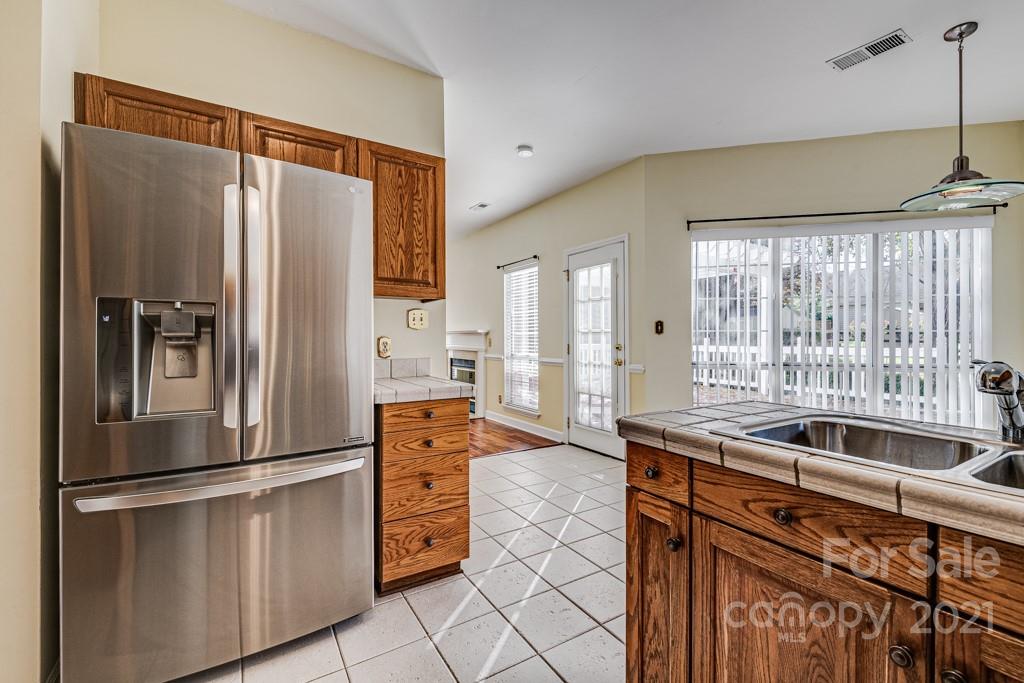 4511 Brownes Ferry Road Charlotte, NC 28269 - Photo 8 of 26 a kitchen with stainless steel appliances granite countertop a refrigerator and a sink