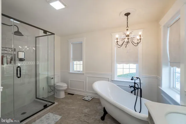 a bedroom with a bed and chandelier